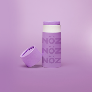 Nöz SPF sunscreen in a vibrant purple color known as "Throwing Shade"