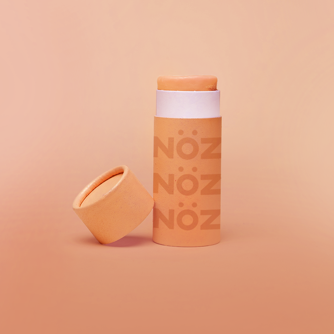 Nöz SPF sunscreen in a bright orange "Orange knows best" color